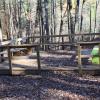 A wooden birding platform with two benches.