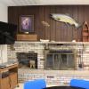 White Pine Lodge common area, with a television, fireplace, and bookshelf.