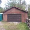 A brown wooden boat house features a sign that says "Brown Memorial Boat house."