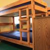 A bunk bed in Maple Lodge with a mattress that has plastic covering.
