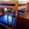 The bottom row of bunk beds in Maple Lodge. A dresser is placed at the foot of each bunk bed.