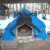 A bright blue handmade outdoor pottery kiln near Red Pine Pavilion.