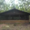 Side view of Red Pine Pavilion, surrounded by trees.