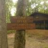 Signs out front of Red Pine Pavilion read "camp office" and "camper registration" with an arrow pointed away from the pavilion.