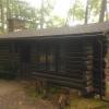 Roth Cabin with two green benches out front.