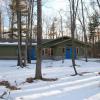 White Pine lodge exterior in winter. The green building has bright blue doors.