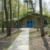 White Pine lodge exterior in summer. The green building has bright blue doors.