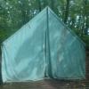 The front of a large green tent on a platform at the White Pine tent site.